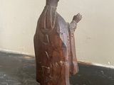 a statue of a man holding a knife on a table