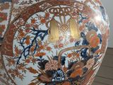 a large vase with a design on it sitting on a stand