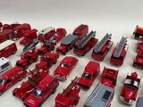 a lot of toy fire trucks that are on the table