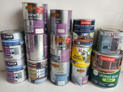 many cans of paint sitting on a shelf next to each other