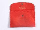 a small red pouch with a small coin inside of it