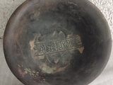 a black bowl that has a handle on it