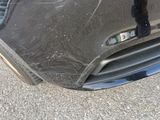 a close up of a car ' s front bumper with a hole in it