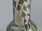 un vase vert orné d'un motif sur l'extérieur