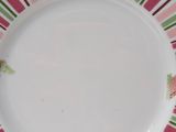 a pink and green plate with a butterfly on it