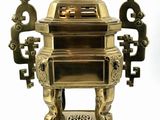 a gold incense box with a dragon on top