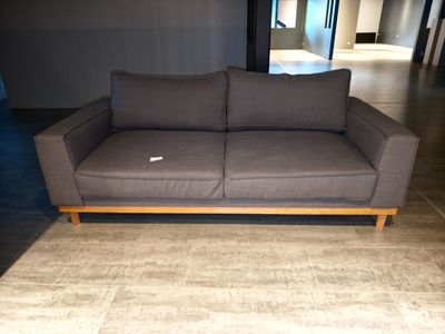 a couch that is sitting on a rug in a room