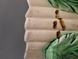 a ceramic figurine of a bird sitting on top of a roof