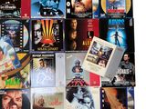 many movie posters on the wall of this room