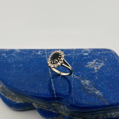 a close up of a blue stone with a ring on it
