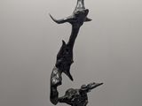 sculpture of a bird and a fish on a marble base