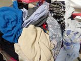 a pile of clothes sitting on top of a table