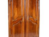 an old wooden armoire with two doors and a drawer