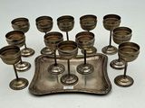 a silver tray with a bunch of wine glasses on it