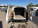 a white van with its doors open in a parking lot