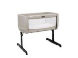 a baby crib with a white cover and black legs
