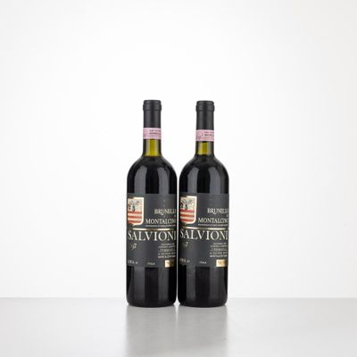 two bottles of wine sitting on top of a table next to each other