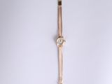 wrist watch on a white surface with a white background