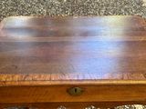 an old wooden table with a drawer on top of it