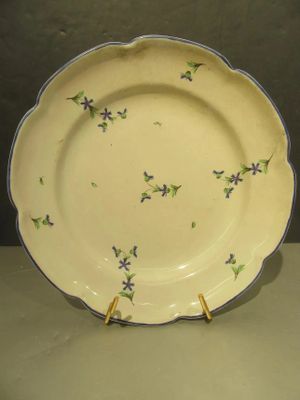 a yellow plate with purple flowers on it
