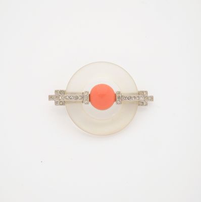 an orange and white ring with diamonds on a white surface