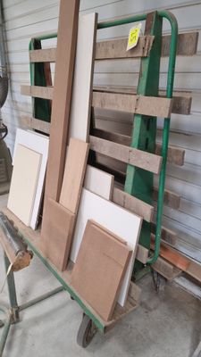 plusieurs morceaux de bois sont empilés sur une charrette dans un garage