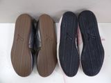 three pairs of shoes are lined up on a white surface