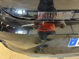 a reflection of a person in a mirror of a car
