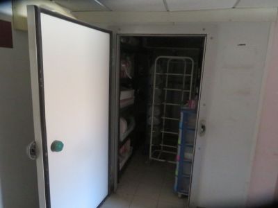 a door that is open in a room with a shelf