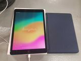 an image of a tablet sitting on top of a table next to a charger