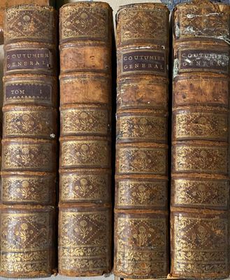 plusieurs vieux livres sont empilés sur une étagère