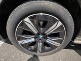 the wheel of a car is shown with a shadow of a person