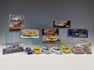 a group of toy cars in display cases on a white surface