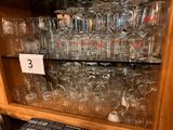a lot of glasses on the shelves in the store