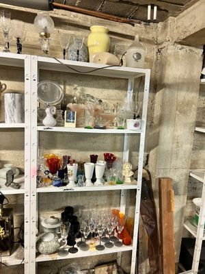 a shelf with a lot of dishes and glasses on it
