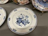 many plates with blue and white designs on them