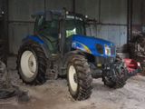 a blue tractor that is parked in a building
