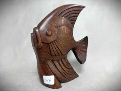 an image of a wooden fish figurine sitting on a table