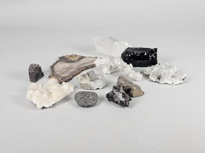 a pile of rocks and crystals on a white surface