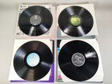three black vinyl records sitting on top of each other on a table