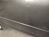 a car that has been painted black in a garage