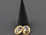 une paire de boucles d'oreilles ornées de fleurs, posées sur un cône noir