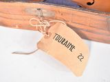 a violin in a case with a tag attached to it