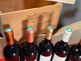 several bottles of wine are lined up in a wooden box