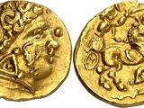 a gold coin with an image of a man riding a horse