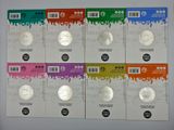 six different coins are in a row on a white surface