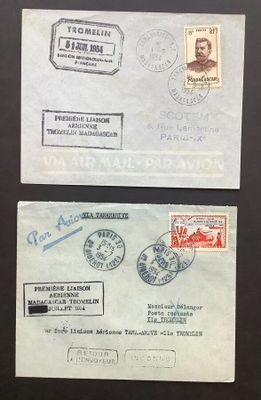 two envelopes with stamps on them sitting on a table