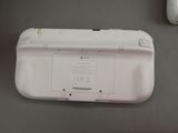 a white nintendo wii game system sitting on a table