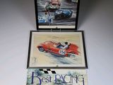 two books on a white table with a picture of a racing car