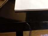 a black table with a white paper and a brown bag on it